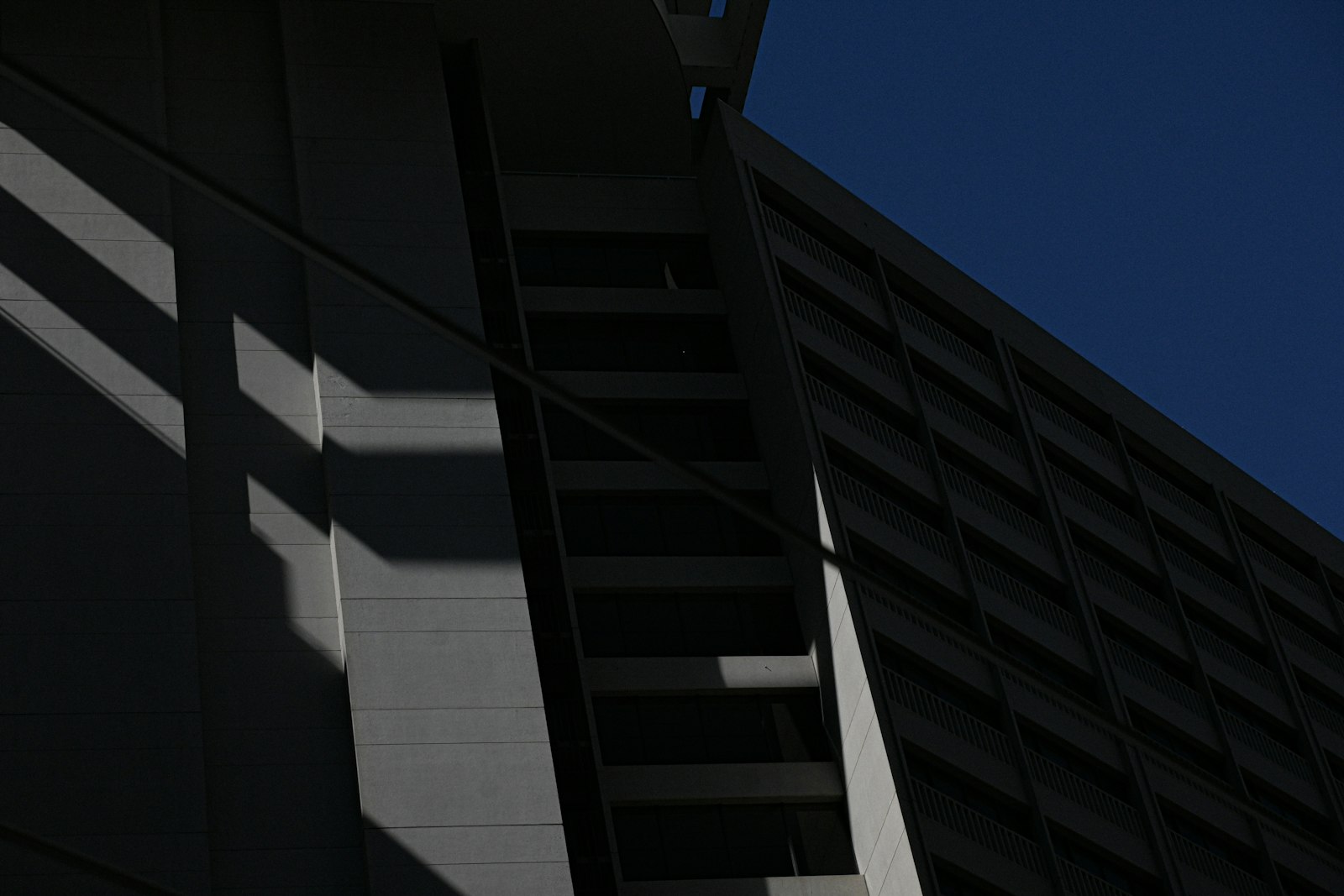 Geometric concrete architecture cut by bands of daylight